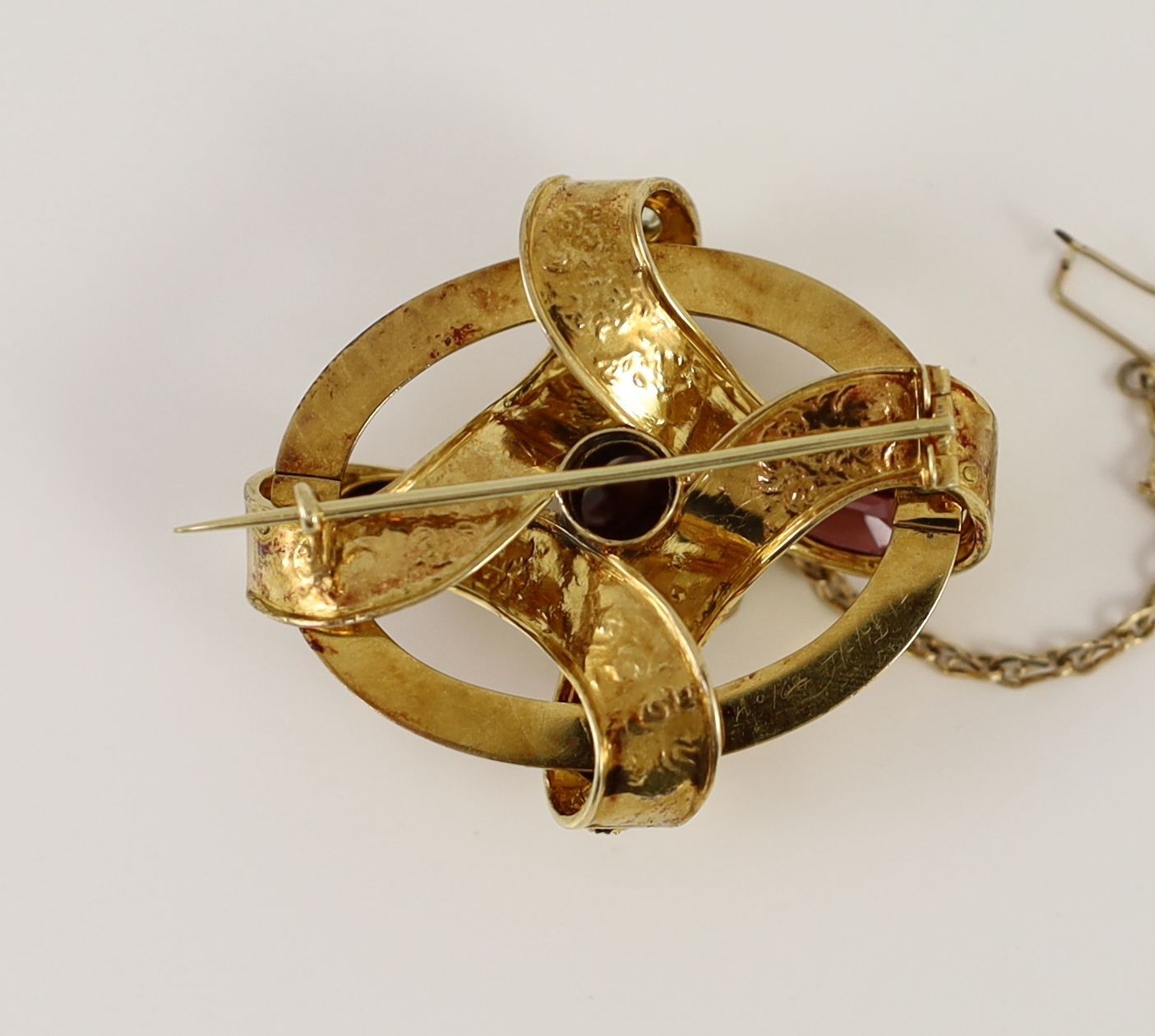 A Victorian engraved gold, chrysoberyl? and garnet set open work scroll brooch